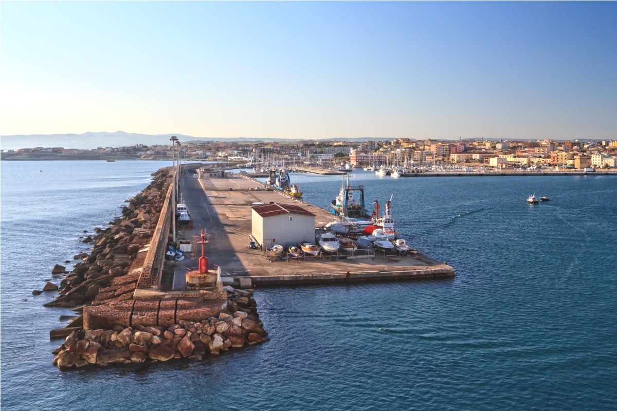 Aerial view of the harbour of Olbia on Sardinia with its long stone breakwater and the town behind